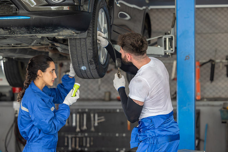 Car Technicians Analyze, Fix Wheel Issues In Garage, Using Preci